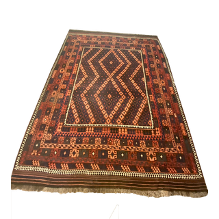 Orange, brown and rust colored persian rug in geometric pattern