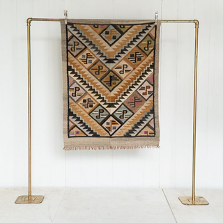 Multi color tribal print rug with small buts of golden fringe