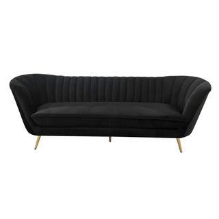 black velvet channel back sofa with gold metal legs.