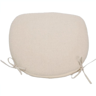 White crossback x-back chair cushion on crossback chairs tucked into white farm tables outdoor.