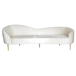 Mid-century modern velvet ivory beige asymmetrical sofa with gold legs in a lounge set including a modern black loveseat, modern black chairs and a square gold coffee table indoors. 