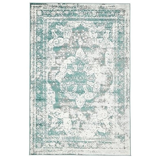 Vintage rectangular teal green rug under a couple embracing and kissing near the ocean with a triangle arbor behind them.