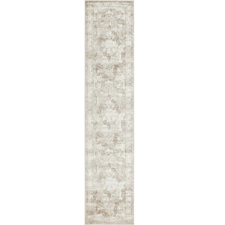 vintage Ivory beige rectangular runner rug under a bride walking towards the end of an aisle while people surround her on each side looking in her direction. Trees are in the background. 