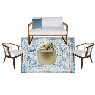 lounge set with ivory beige wood loveseat with a gold round coffee table with wood and white arm chairs on either side of the coffee table on a blue pattern rug.