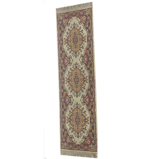 vintage boho red rectangular runner rug outdoors on grass facing a geommetric arbor with a boho decor on it and around the aisle withtrees in the background. 