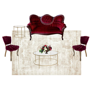 lounge set with burgundy red loveseat with a gold round coffee table with vintage tufted red chairs on each side of the coffee table with side table.