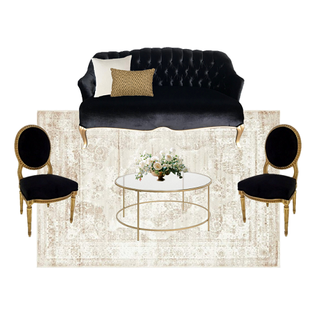 lounge set with black vintage loveseat with a round gold coffee table with a vintage black and gold chair on each side of the coffee table over a beige ivory rug.