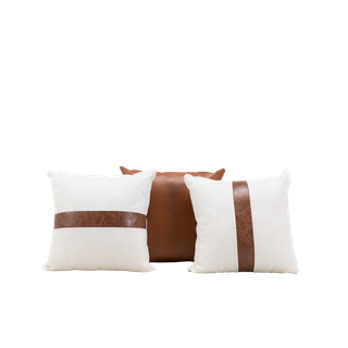 trio of leather and white pillows