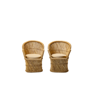 pair of wicker peacock chairs with neutral cushions 