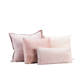 four blush pink pillows on white background