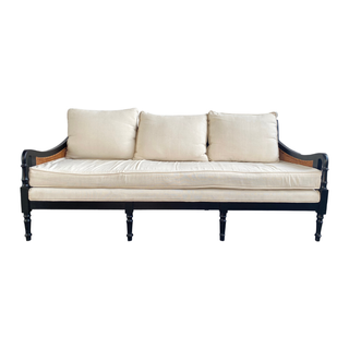 Cream sofa with black and cane detailing on sides and back availble for event rentals