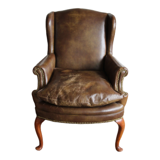 Brown leather wingback accent chair for event lounges and parties