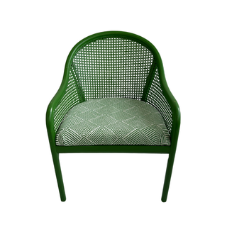 Bright green rattan chair with modern green and white patterned upholstered seat