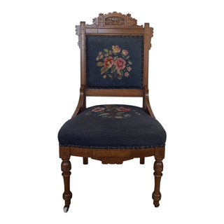 Floral embroidered navy blue dininh chair with ornate wood detail
