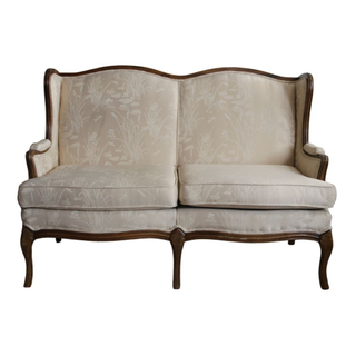 Cream and white settee with a light floral pattern perfect for a lounge or sweetheart seating 