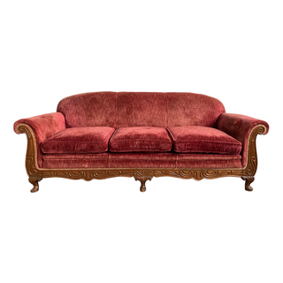 Red velvet antique sofa with wood detailing from Relics Rentals in Milwaukee