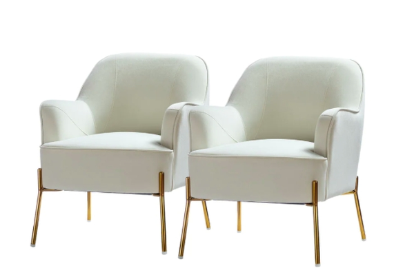 two white velvet chairs with gold legs 