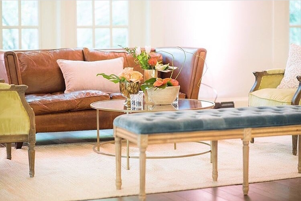 Leather sofa with colorful chairs and bench with gold coffee table 