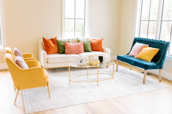 white sofa with yellow chairs and blue settee
