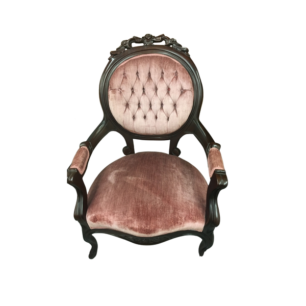 pink velvet tufted vintage chair with dark wood trim 