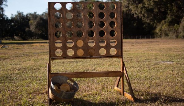 Stained wood connect four comes with dark and light solid wood disks 