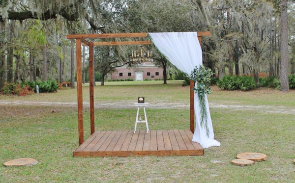 Stained pergola with floor. for florals and drapes