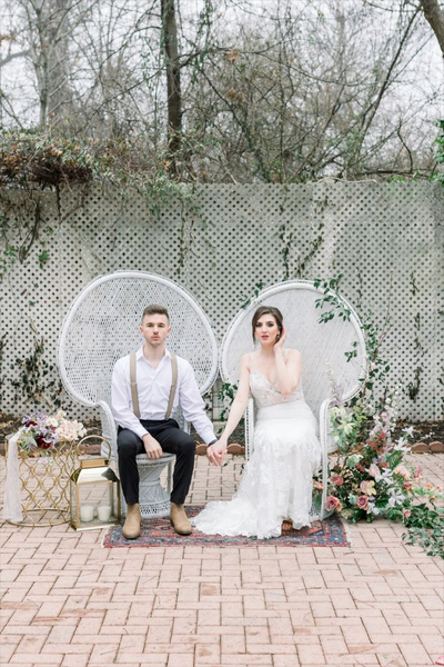 Boho rattan white ivory peacock chairs with a couple sitting over each one. 