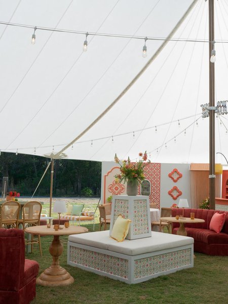 wedding reception with white estate banquette rental with custom wallpaper application
