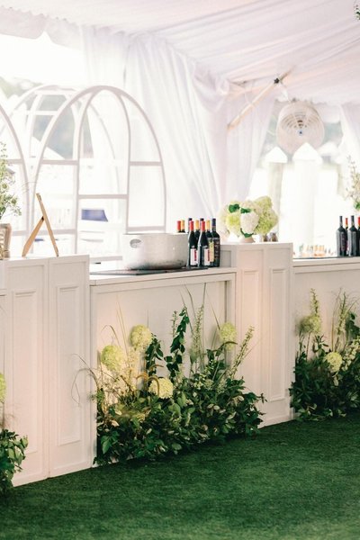 event with white bar rental surrounded by white columns