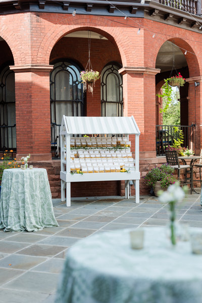 white and green three-tier freestanding shelf as wedding cocktail hour decor