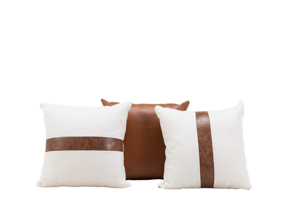 trio of leather and white pillows available as event rentals
