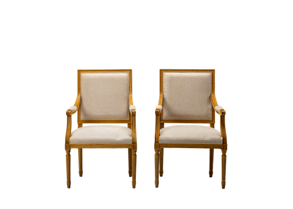 pair of neutral linen square back side chairs with wood trim