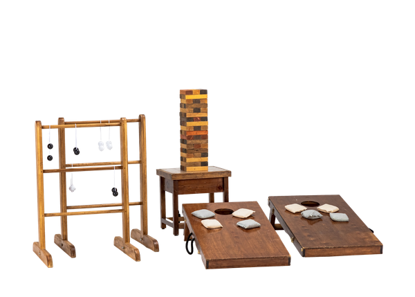 collection of lawn games including a pair of wooden cornhole boards, large wooden jenga set, and a ladder ball set