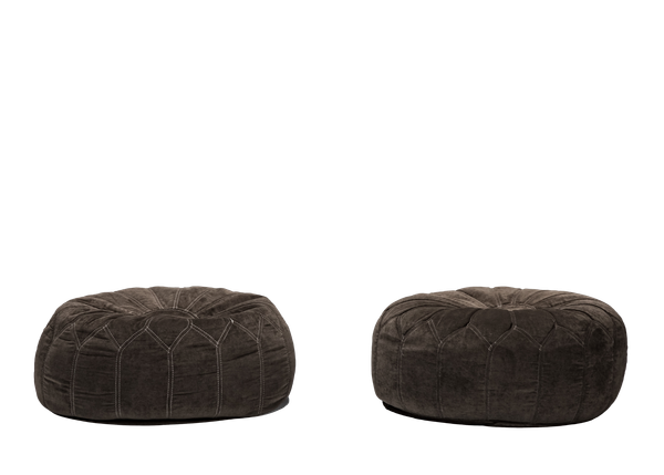 pair of dark gray round velvet poufs 