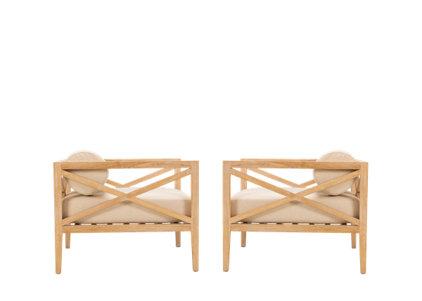 side view of pair of light wood armchair rentals with neutral cushions