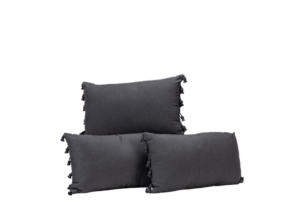 trio of black lumbar pillows with black tassels on the sides