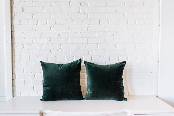 Pair of dark green velvet square pillows 