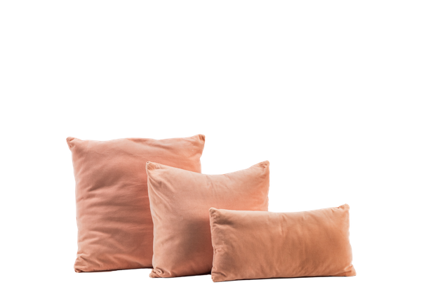 3 pink pillows in varying sizes 