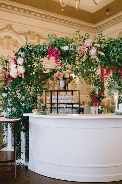 wedding reception with white round bar event rental with traditional molding and a white truss