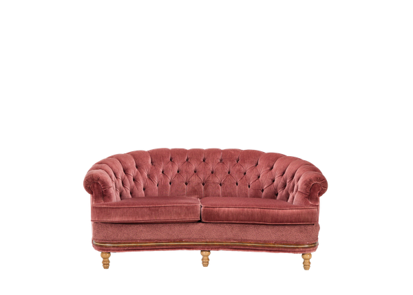 mauve curved back settee with a tufted back and wooden legs