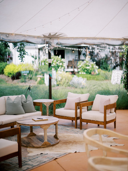 wedding reception decorated with pink and blue patterned traditional rug 
