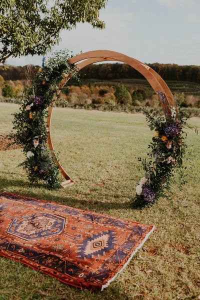 red boho rug rental as wedding decor