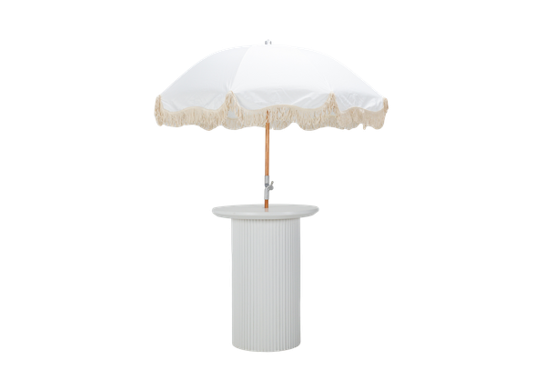 white cocktail table featuring a round top and ribbed texture with a white fringe umbrella