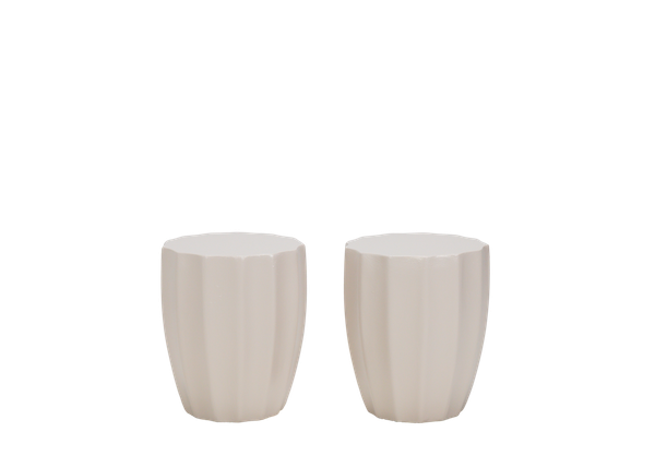 pair of neutral end tables with a fluted texture and round top and base