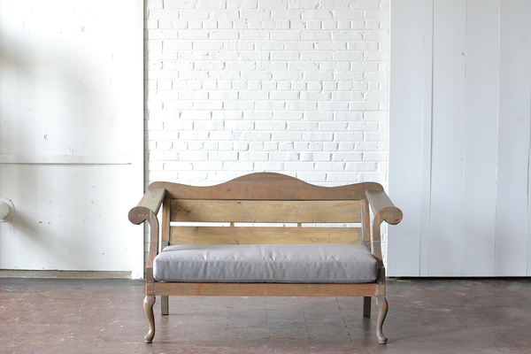 honey gray wooden loveseat with gray upholstery 