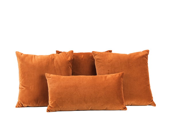 four copper velvet pillows