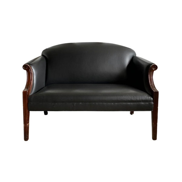 Rentable from Relics Rentals this sleak black vinyl settee will be the star of any lounge 