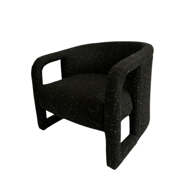 Modern black upholstered chair with curved arms and cut out sides