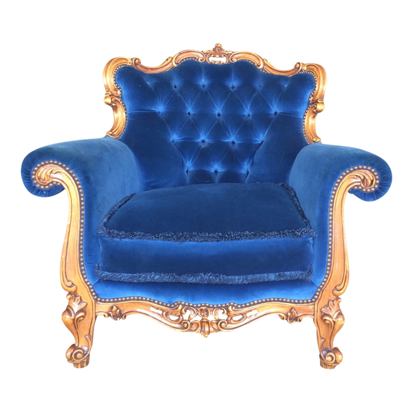 Royal blue tufted lounge chair with ornate wood details for rent from Relics Rentals in Milwaukee, WI