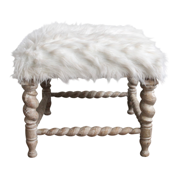 White shag ottoman with detailed carved wood legs that is the perfect accent in a lounge